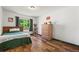 Well-lit bedroom with hardwood floors and large window at 11861 Fairplay St, Commerce City, CO 80603