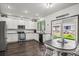 Bright kitchen with white cabinets, stainless steel appliances, and an eat-in area at 11861 Fairplay St, Commerce City, CO 80603