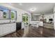 Open kitchen with dark wood floors, white cabinets, and a view of the living room at 11861 Fairplay St, Commerce City, CO 80603