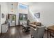 Bright living room boasts hardwood floors, high ceilings, and large windows at 11861 Fairplay St, Commerce City, CO 80603