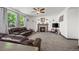 Comfortable living room with a fireplace, plush furniture, and natural light at 11861 Fairplay St, Commerce City, CO 80603