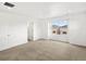 Bright bedroom with neutral carpet, large window, and white trim at 546 Red Rock Pl, Brighton, CO 80601