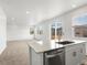 Bright eat-in kitchen featuring white cabinetry, stainless steel appliances, and granite countertops at 546 Red Rock Pl, Brighton, CO 80601