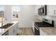 Modern kitchen with granite countertops and stainless steel appliances at 546 Red Rock Pl, Brighton, CO 80601