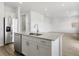 Open-concept kitchen showcasing a center island with granite countertops and stainless steel appliances at 546 Red Rock Pl, Brighton, CO 80601