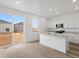 Stylish kitchen featuring white cabinets, stainless steel appliances, and a center island with granite countertops at 546 Red Rock Pl, Brighton, CO 80601