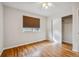 Bedroom with hardwood floors, white walls, white trim, a closet, ceiling fan and a window at 11716 W Belleview Dr, Littleton, CO 80127