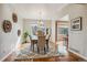 Elegant dining room featuring hardwood floors, a modern rug, and stylish decor at 11716 W Belleview Dr, Littleton, CO 80127