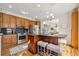 Beautiful kitchen featuring an island with seating and stainless steel appliances at 11716 W Belleview Dr, Littleton, CO 80127