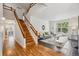 Bright living room with hardwood floors, a staircase, and plenty of natural light at 11716 W Belleview Dr, Littleton, CO 80127