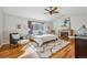 Sunlit main bedroom with a vaulted ceiling, fireplace, and plush decor at 11716 W Belleview Dr, Littleton, CO 80127