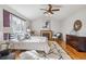 Relaxing main bedroom with a fireplace, hardwood floors, and natural light at 11716 W Belleview Dr, Littleton, CO 80127