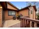 Cozy outdoor deck with wood railings features stylish seating and a neutral outdoor rug at 9409 W 89Th Cir, Broomfield, CO 80021