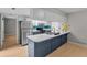 Bright kitchen featuring an island, white cabinetry, and stainless steel appliances at 9409 W 89Th Cir, Broomfield, CO 80021