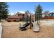 Community playground features a slide and climbing structure with wood chip ground cover at 9409 W 89Th Cir, Broomfield, CO 80021