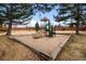 Neighborhood playground with wood chipped surface and a wooden perimeter, includes a slide and climbing features at 9409 W 89Th Cir, Broomfield, CO 80021