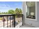 A balcony with metal railings that offers serene neighborhood views and hints of a modern interior design at 8711 E Hampden Ave # 23, Denver, CO 80231
