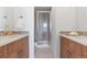 Elegant bathroom featuring double vanity with wood cabinets, modern fixtures, and shower with glass door at 8711 E Hampden Ave # 23, Denver, CO 80231