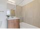 Bathroom featuring a modern vanity with countertop basin, a bathtub with tiled surround, and contemporary fixtures creating a spa-like retreat at 8711 E Hampden Ave # 23, Denver, CO 80231