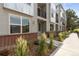 Exterior view of a gray townhome with a landscaped walkway and front door at 8711 E Hampden Ave # 23, Denver, CO 80231