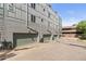 Row of garages attached to a multi-level residential building, offering convenient parking and storage solutions at 8711 E Hampden Ave # 23, Denver, CO 80231