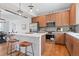 Modern kitchen features stainless steel appliances, light countertops, and wood cabinets with seating at 8711 E Hampden Ave # 23, Denver, CO 80231