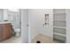 Bathroom and laundry room combination features a modern vanity, toilet, and washer/dryer hookups, combining functionality with style at 8711 E Hampden Ave # 23, Denver, CO 80231