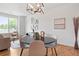 Bright dining room with hardwood floors, modern decor, and natural light at 8711 E Hampden Ave # 23, Denver, CO 80231