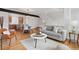 Open-concept living room with hardwood floors, modern furniture, and view of the kitchen at 8711 E Hampden Ave # 23, Denver, CO 80231