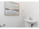 Stylish powder room featuring modern fixtures, sink, painting and contemporary design at 8711 E Hampden Ave # 23, Denver, CO 80231