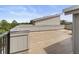 A roof top deck featuring a flat, open space with light grey panels and a partial view of the surroundings at 8711 E Hampden Ave # 23, Denver, CO 80231