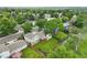 Aerial shot of a home with a green lawn, wood deck, storage shed, and privacy fence at 9306 Garrison Dr, Broomfield, CO 80021