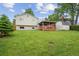 Expansive backyard featuring a spacious deck area, lush green lawn, and a storage shed at 9306 Garrison Dr, Broomfield, CO 80021