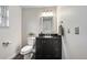 Elegant bathroom with a black vanity, updated fixtures, and a coordinating mirror offers a modern touch at 9306 Garrison Dr, Broomfield, CO 80021