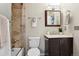 Updated bathroom with tiled shower/tub and modern vanity at 9306 Garrison Dr, Broomfield, CO 80021