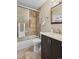 Contemporary bathroom with tiled shower/tub and dark wood vanity at 9306 Garrison Dr, Broomfield, CO 80021