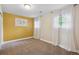 Bright bedroom boasts natural light from two windows, plush carpet, and a colorful accent wall at 9306 Garrison Dr, Broomfield, CO 80021