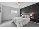 Cozy bedroom featuring a star-accented accent wall and plush carpet at 9306 Garrison Dr, Broomfield, CO 80021