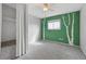 Neutral bedroom featuring a custom painted green wall and tree accents at 9306 Garrison Dr, Broomfield, CO 80021