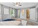 Neutral bedroom featuring plush carpet, natural light and access to an ensuite bathroom at 9306 Garrison Dr, Broomfield, CO 80021