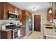 Well-equipped kitchen with stainless steel appliances, granite countertops, and wood cabinets at 9306 Garrison Dr, Broomfield, CO 80021