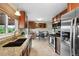 Modern kitchen features stainless steel appliances, granite countertops, and a view of the breakfast nook at 9306 Garrison Dr, Broomfield, CO 80021