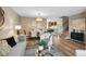 Open-concept living area with dining space, wood floors, and staircase at 9306 Garrison Dr, Broomfield, CO 80021