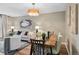 Open-concept living room and dining room with modern decor, wood floors, and chandelier at 9306 Garrison Dr, Broomfield, CO 80021