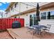 Back deck with outdoor seating, string lights, grill, and access to the home at 12933 E Louisiana Ave, Aurora, CO 80012