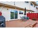 Back deck featuring an outdoor dining set, grill, and string lights at 12933 E Louisiana Ave, Aurora, CO 80012