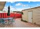 Cozy backyard features a wooden deck, patio furniture, string lights, and access to an outdoor storage shed at 12933 E Louisiana Ave, Aurora, CO 80012