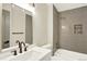 Bathroom showcasing a tub and shower combo, updated tile surround, and a modern vanity at 12933 E Louisiana Ave, Aurora, CO 80012
