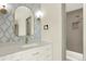 Stylish bathroom features a modern vanity, gold hardware, and a tiled shower at 12933 E Louisiana Ave, Aurora, CO 80012