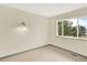 Bedroom with neutral carpet and paint, natural light, and updated wall sconces at 12933 E Louisiana Ave, Aurora, CO 80012